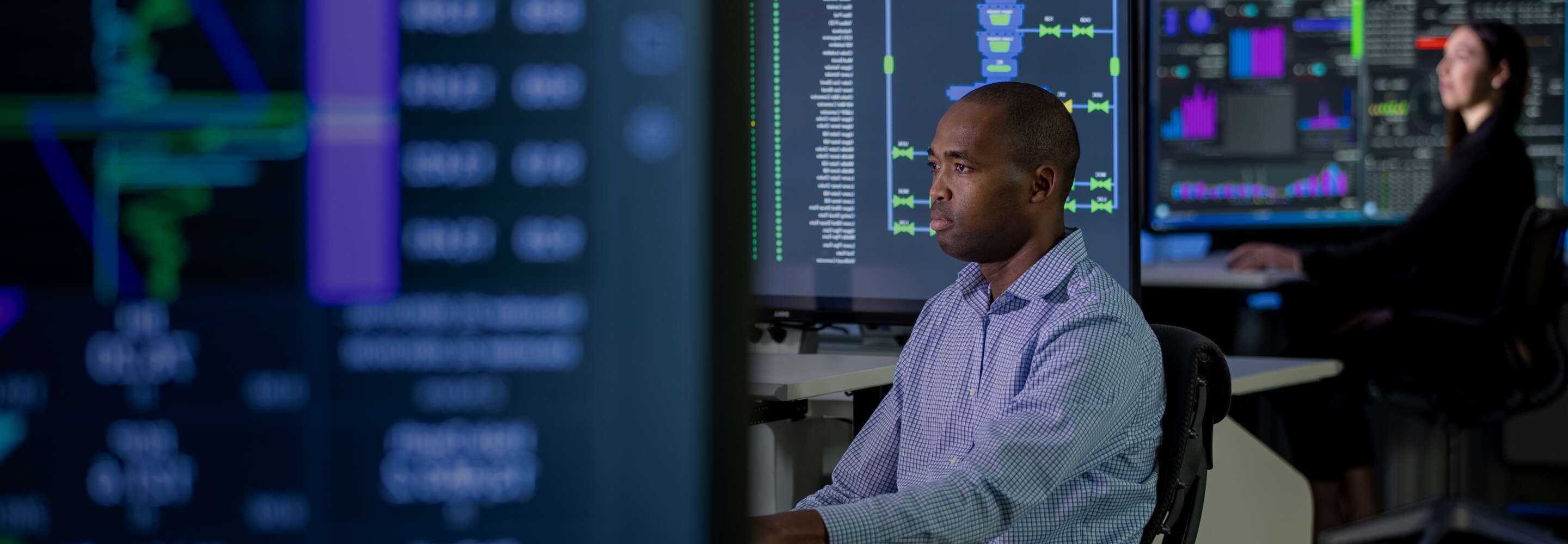 two analysts looking at computer screens